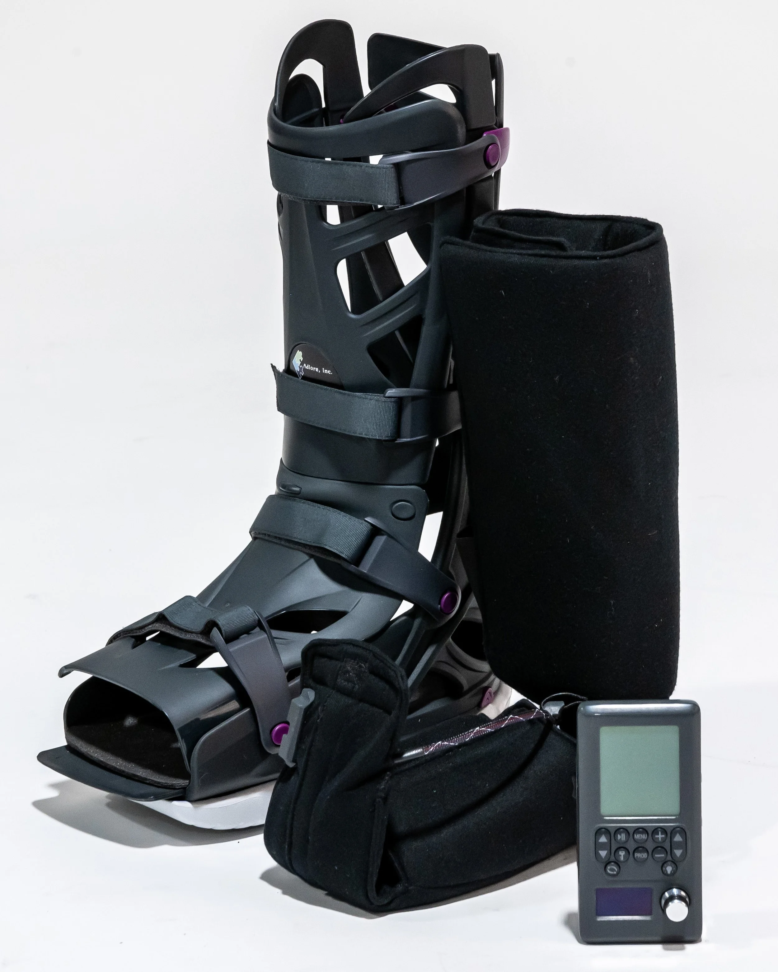 SenLore prototype kit: pair of rigid-shell boots, handheld controller, and Adlore hard case
